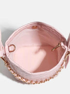 Pink quilted crossbody bag with gold chain strap and interior pocket