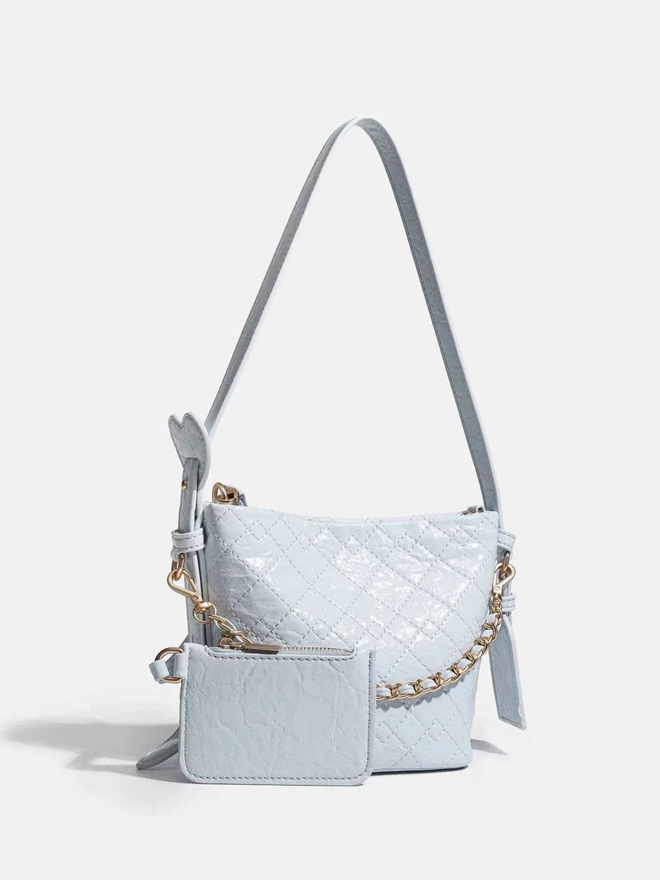 Light blue quilted crossbody bag with gold chain strap and matching wallet, trendy fashion accessory