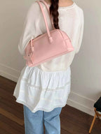 Pink shoulder bag with star charm, stylish fashion accessory for women