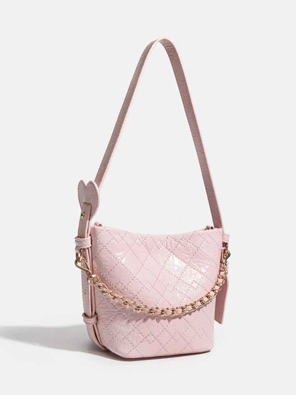 Pink quilted crossbody bag with gold chain strap and heart detail, stylish fashion accessory