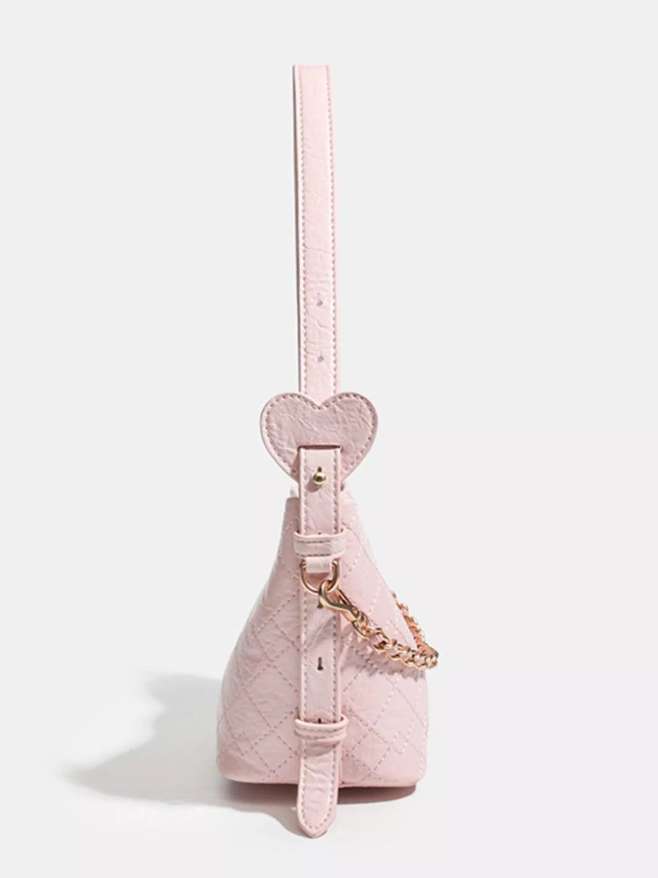 Pink quilted handbag with heart-shaped strap and gold chain detail, trendy fashion accessory