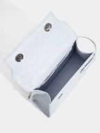 Light blue glittery clutch bag with snap buttons and interior compartments, ideal for evening accessories.