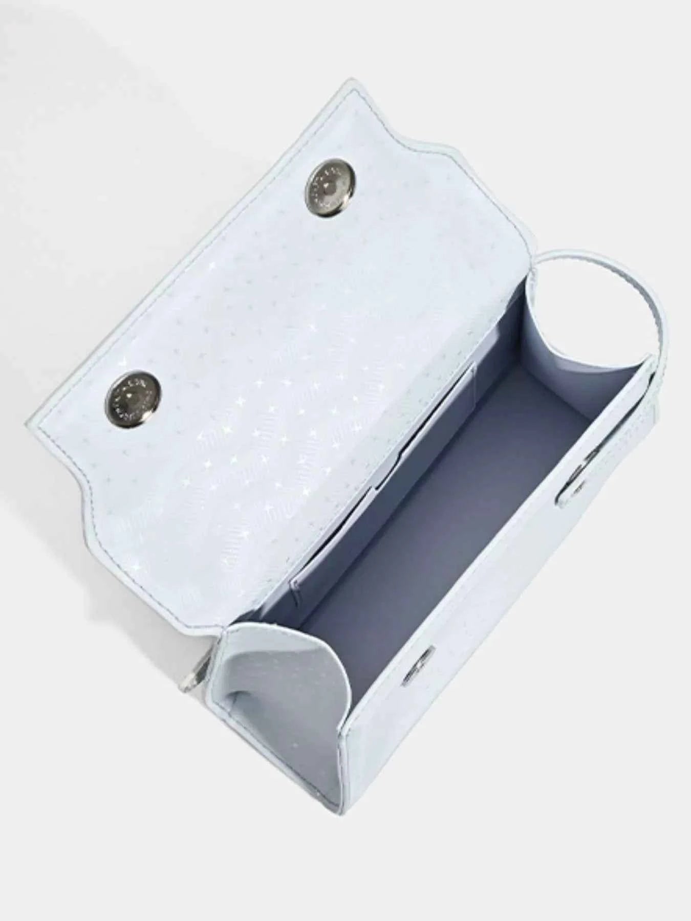 Light blue glittery clutch bag with snap buttons and interior compartments, ideal for evening accessories.