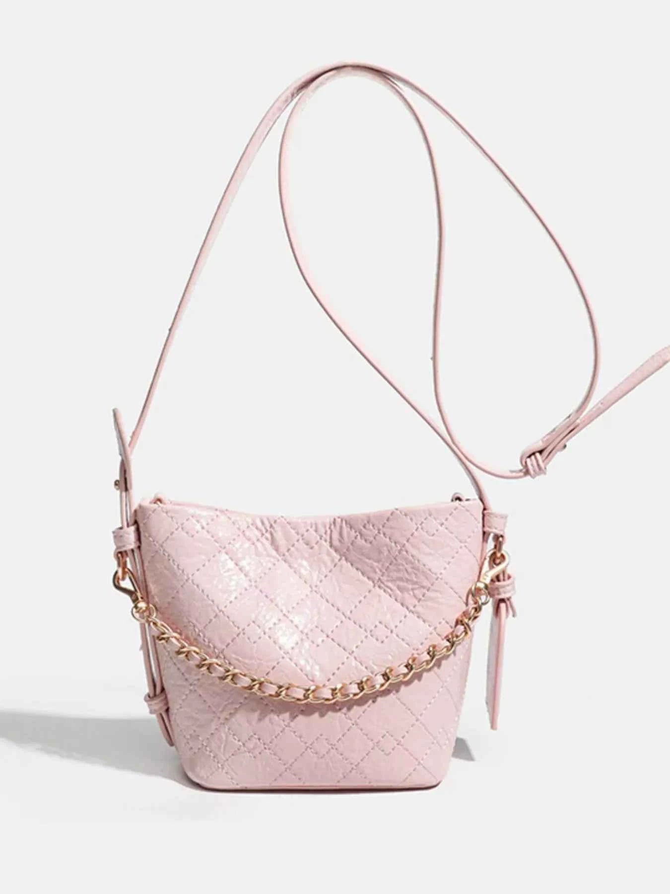 Pink quilted bucket bag with gold chain strap, stylish fashion accessory for women