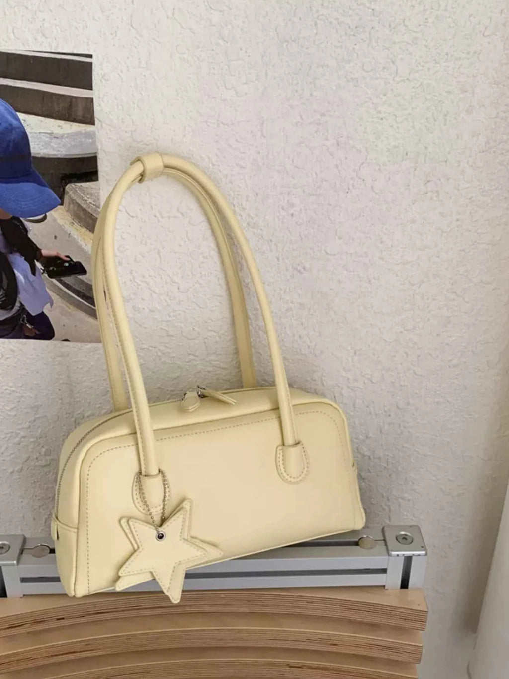 Cream bowler bag with star charm, trendy fashion accessory for women