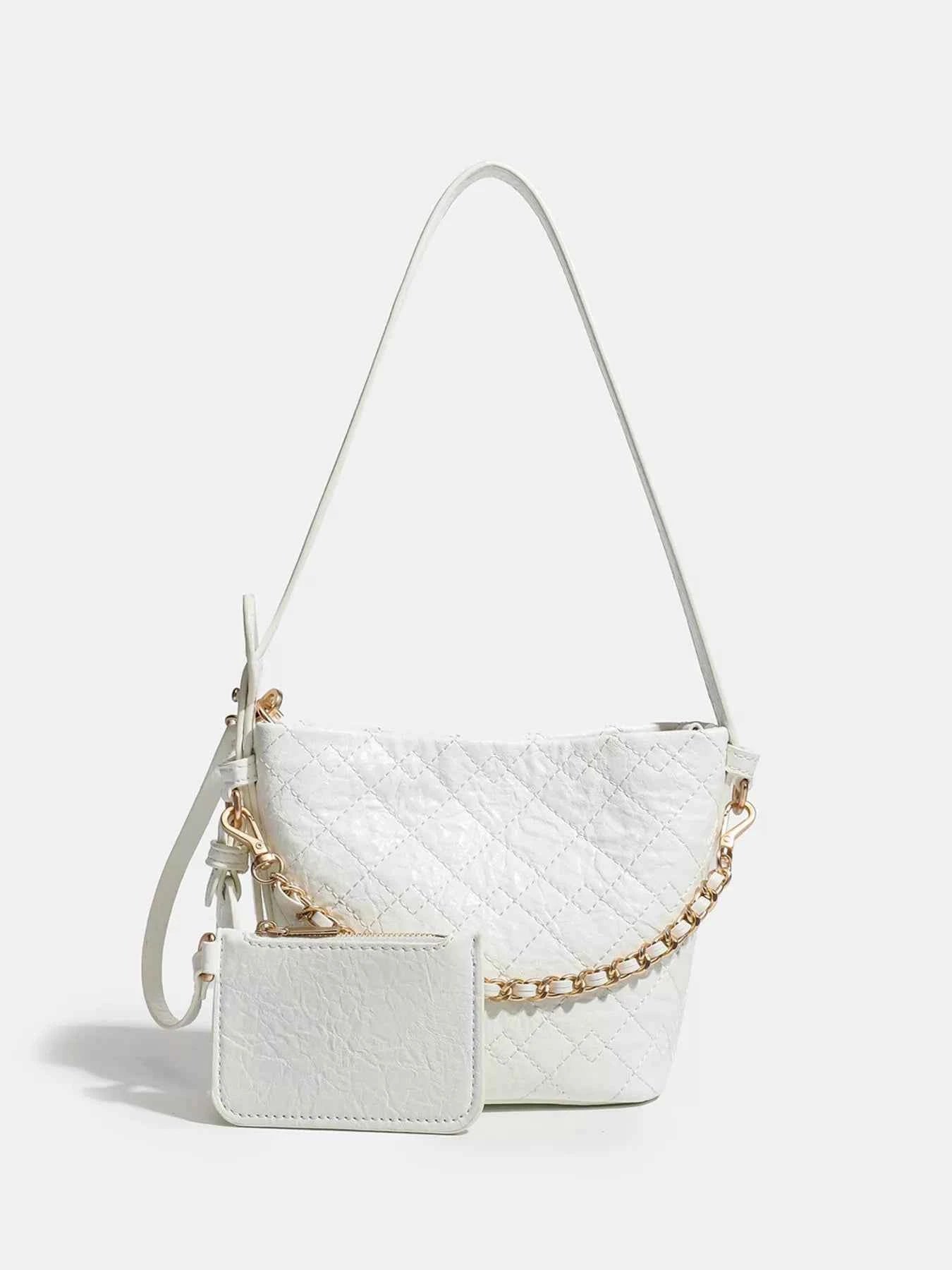White quilted crossbody bag with gold chain strap and matching wallet, trendy fashion accessory