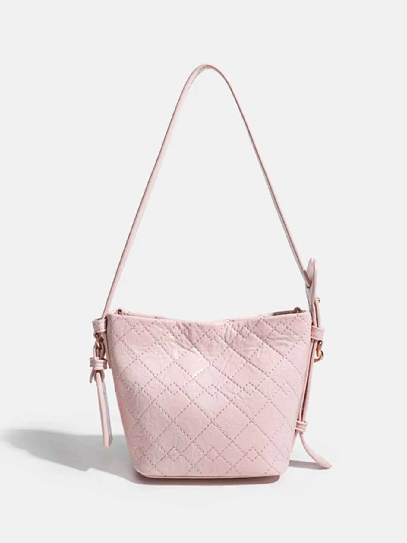 Pink quilted bucket bag with adjustable strap, stylish fashion accessory for women
