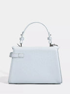 Light blue textured handbag with top handle and silver hardware, stylish fashion accessory