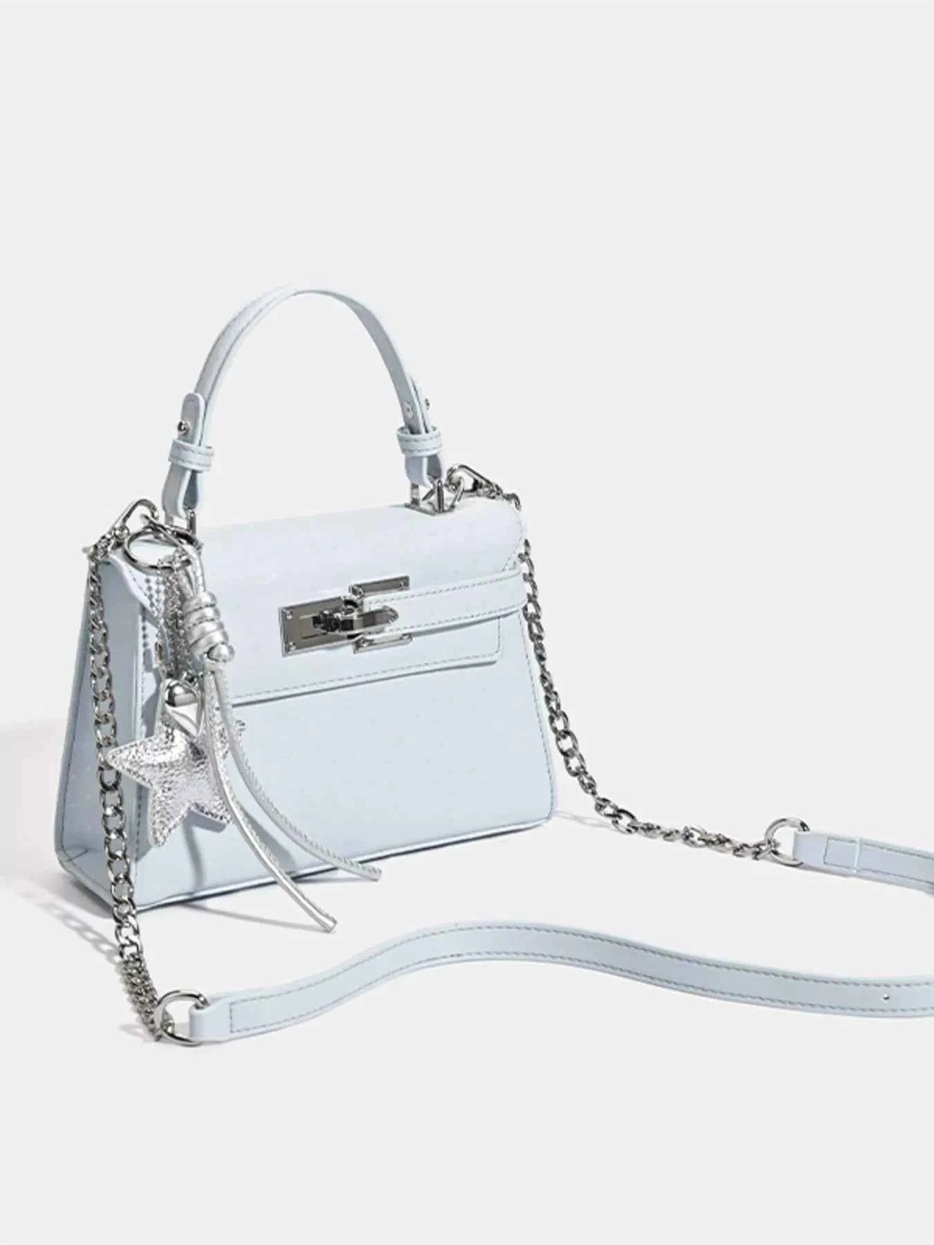 Light blue fashion handbag with chain strap and star charm, stylish accessory for women