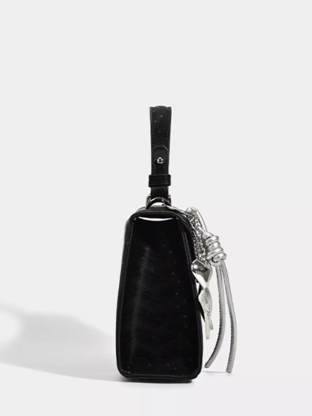 Black textured mini handbag with silver chain strap and tassel detail, stylish fashion accessory