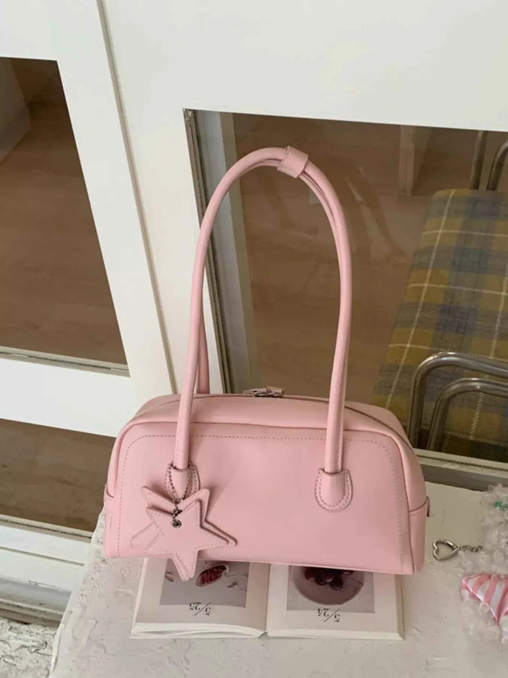 Pink bowler bag with star charm, trendy fashion accessory for women