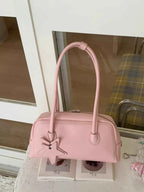 Pink bowler bag with star charm, trendy fashion accessory for women