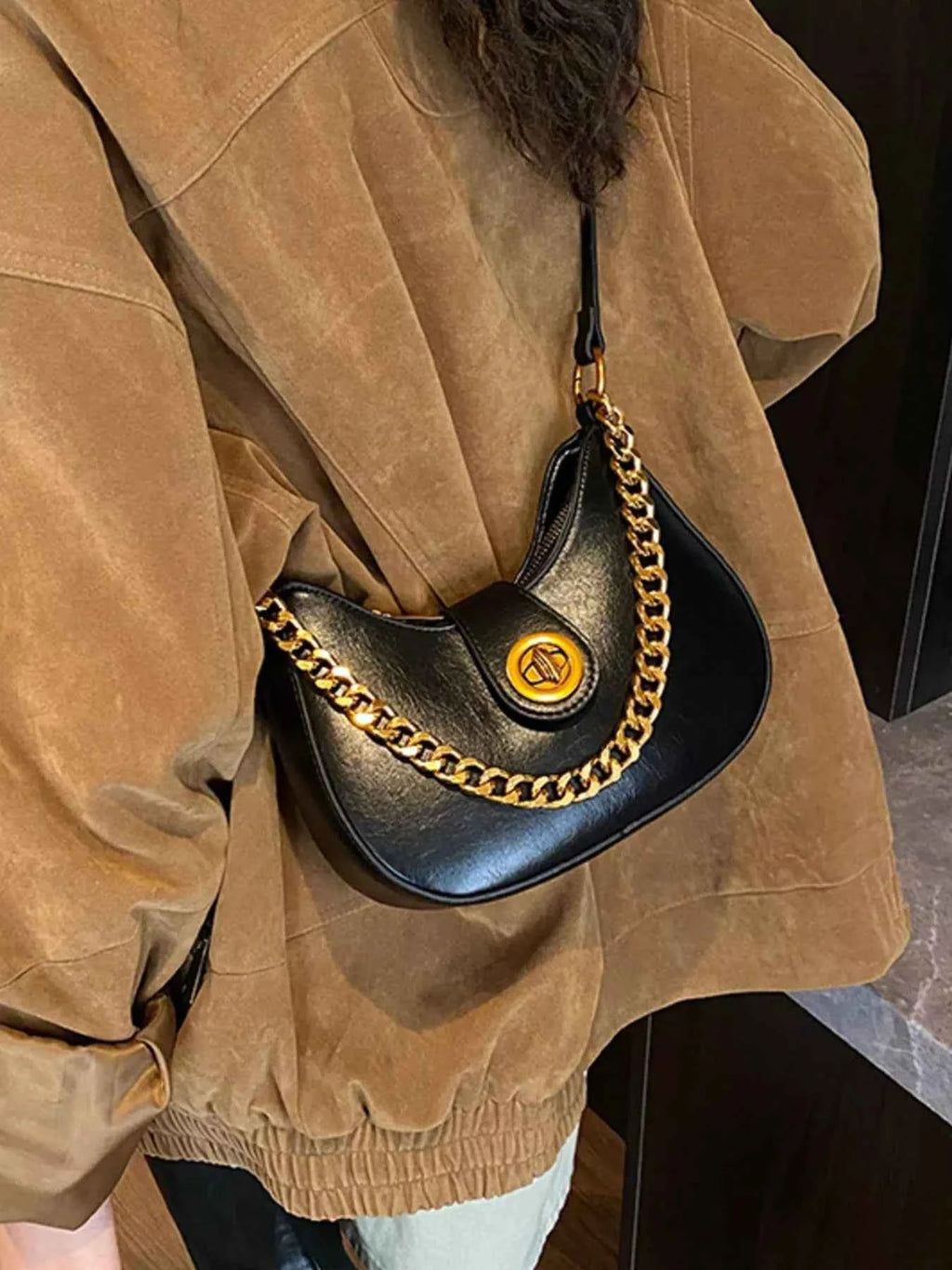 Black crescent moon bag with gold chain strap, stylish accessory for women's fashion