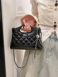 Black quilted handbag with chain strap and top handle, fashion accessory for women