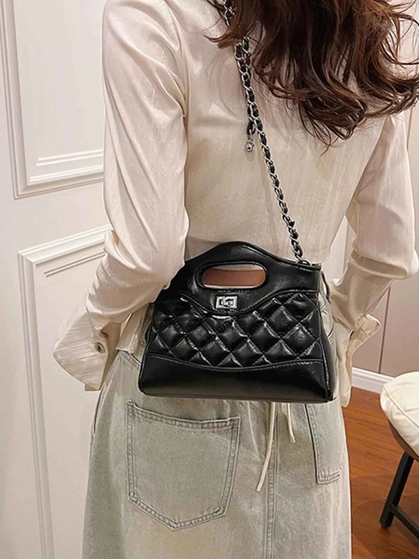 Black quilted handbag with chain strap, stylish fashion accessory for women