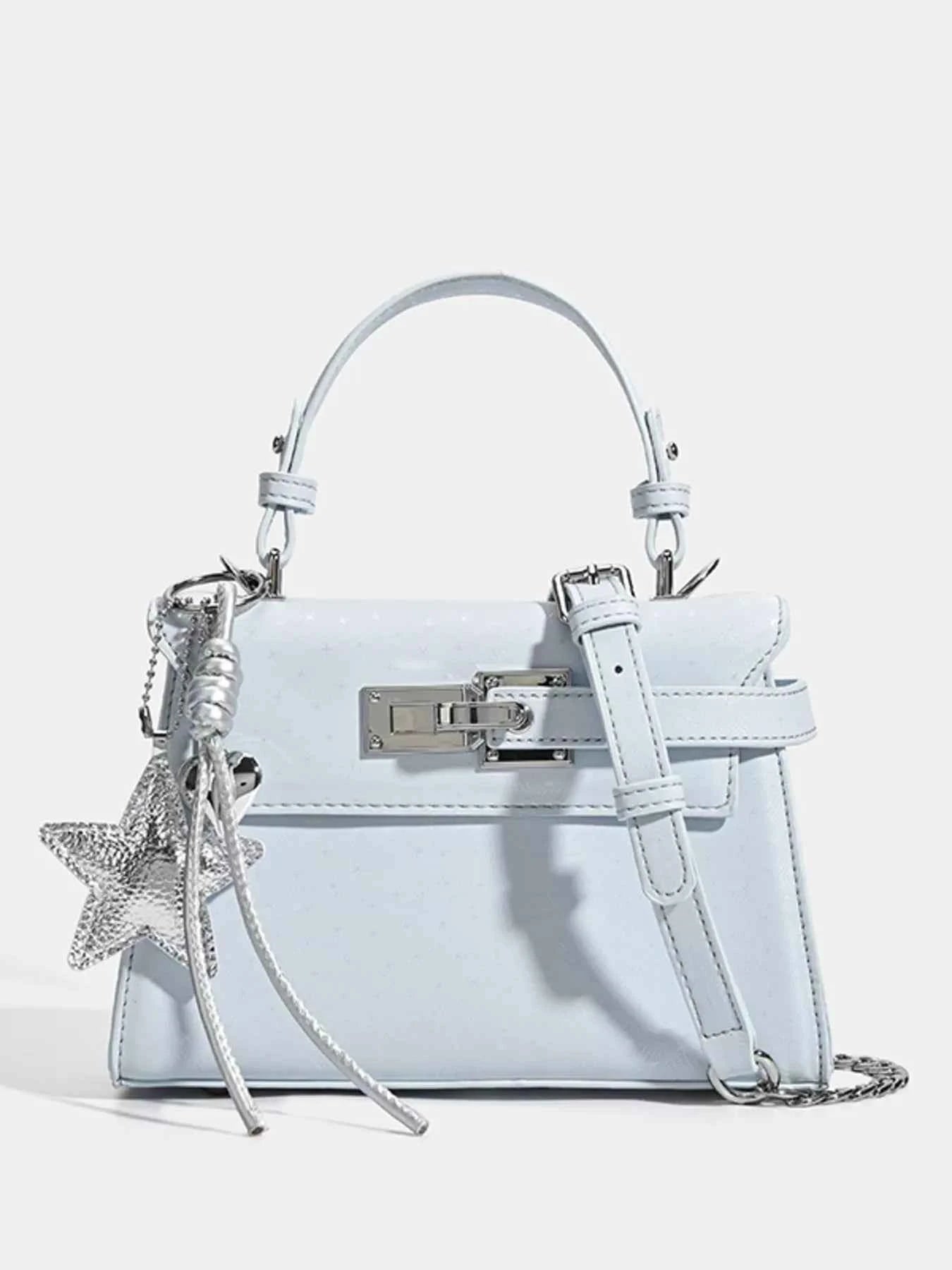 Light blue fashion handbag with star charm, top handle, and chain strap for women
