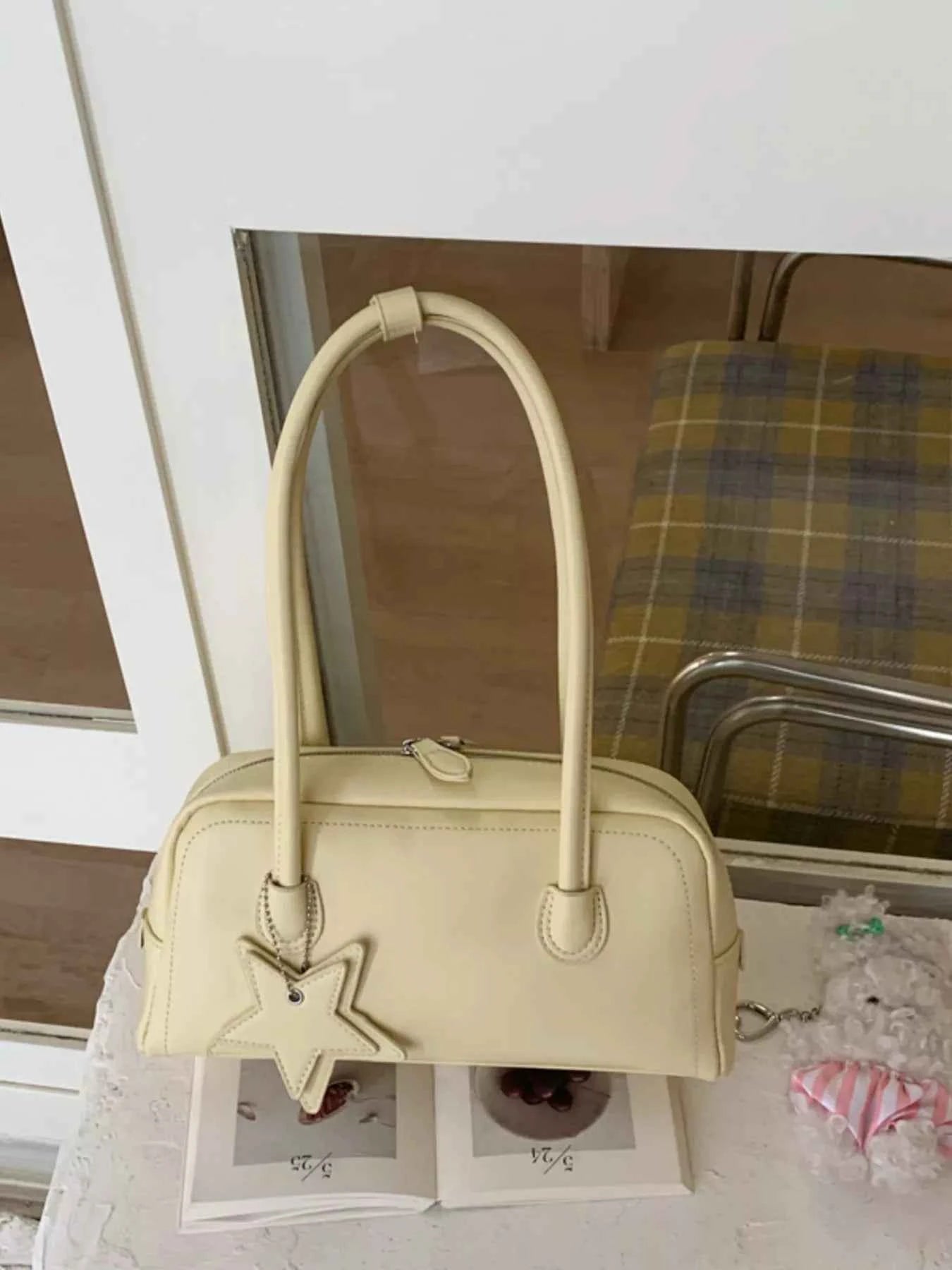 Cream bowler bag with star charm, trendy fashion accessory for women