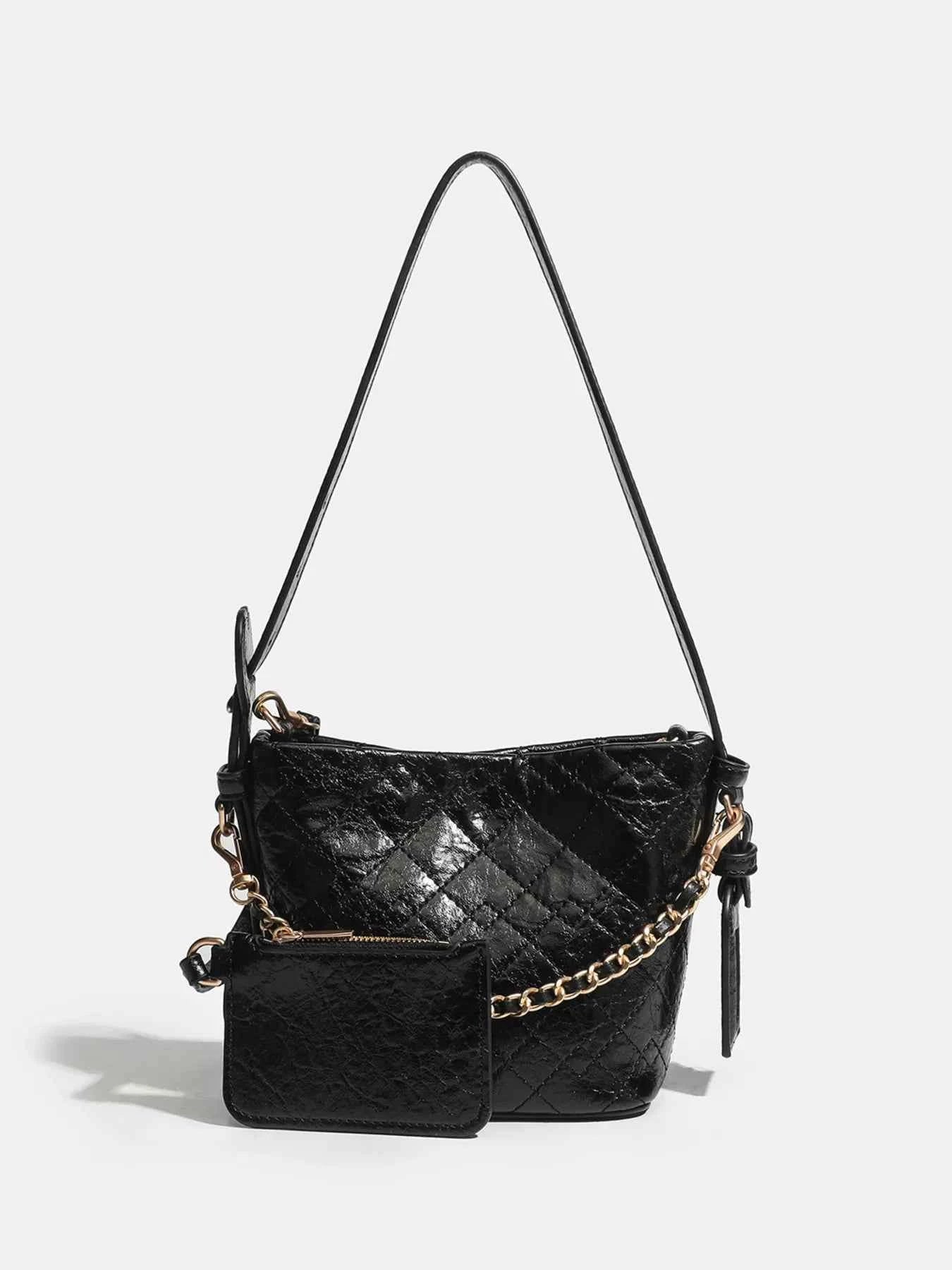 Black quilted shoulder bag with gold chain strap and matching pouch, stylish fashion accessory